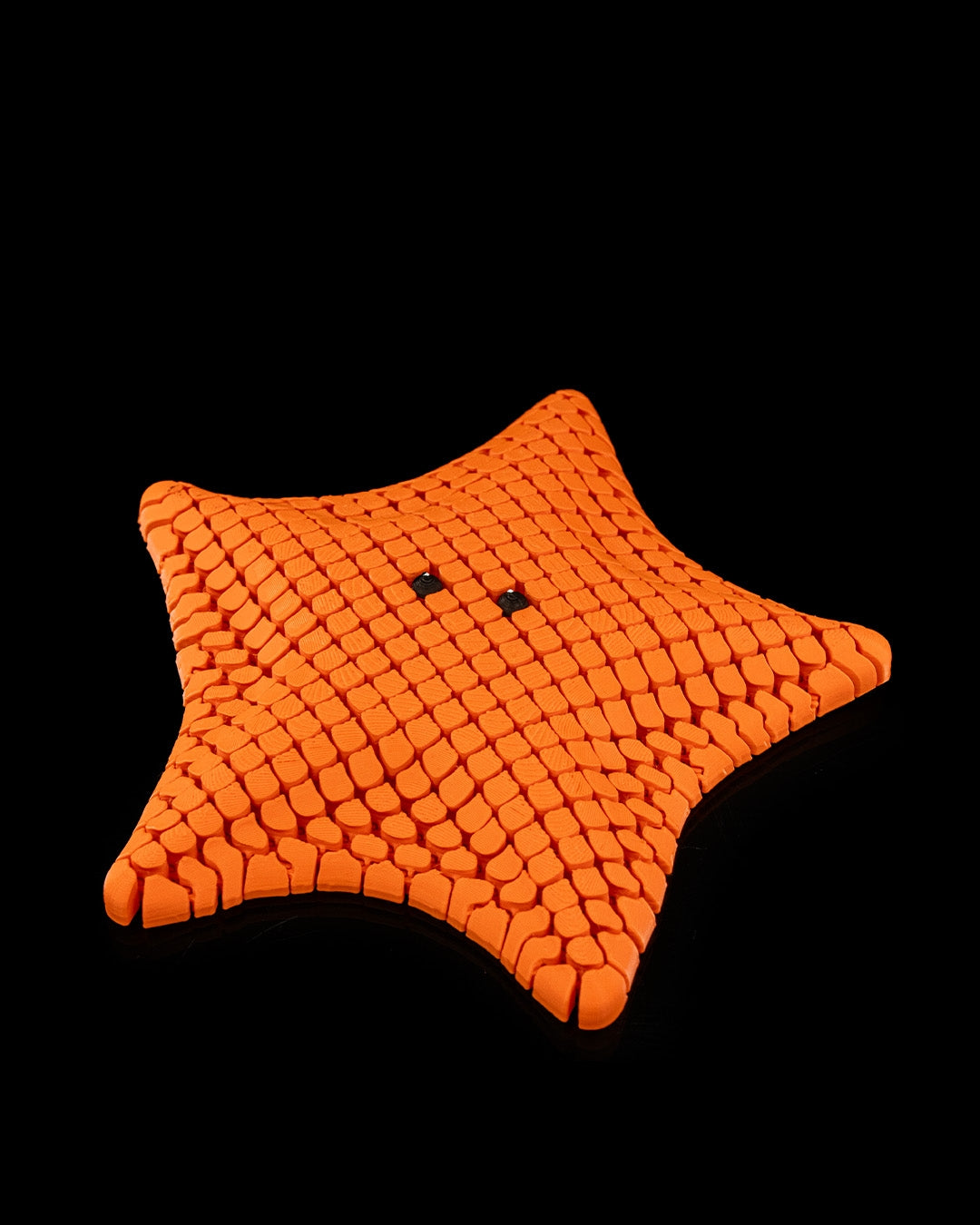 3D printed articulated sea star figure named Betsie, shown in multiple colors