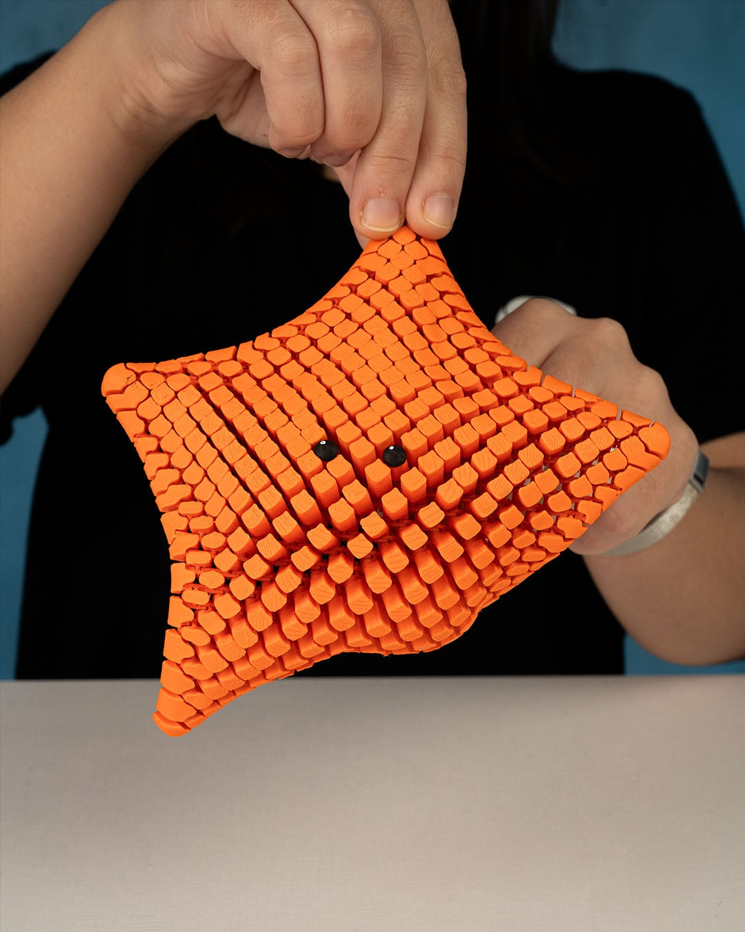 3D printed articulated sea star figure named Betsie, shown in multiple colors