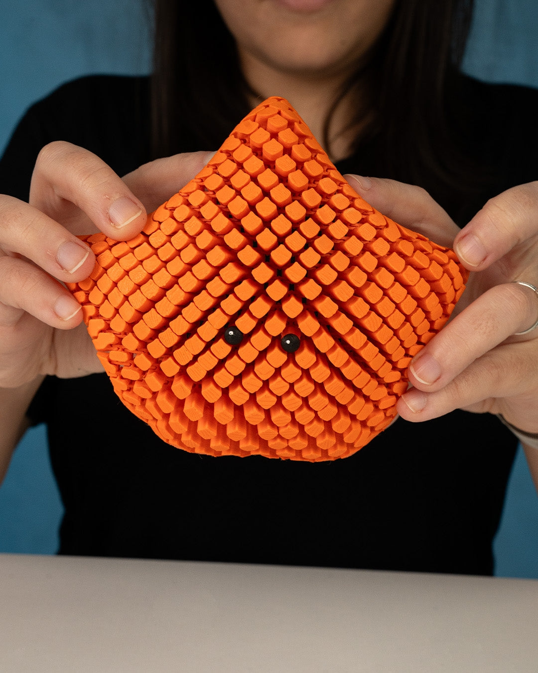 3D printed articulated sea star figure named Betsie, shown in multiple colors