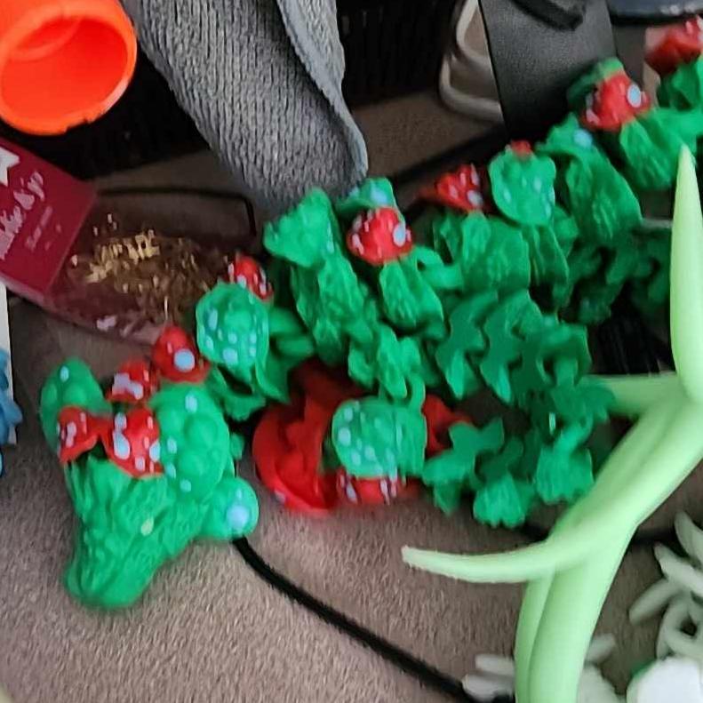 3D printed Mushroom Dragon articulated fidget toy with glow-in-the-dark blue eyes and feet