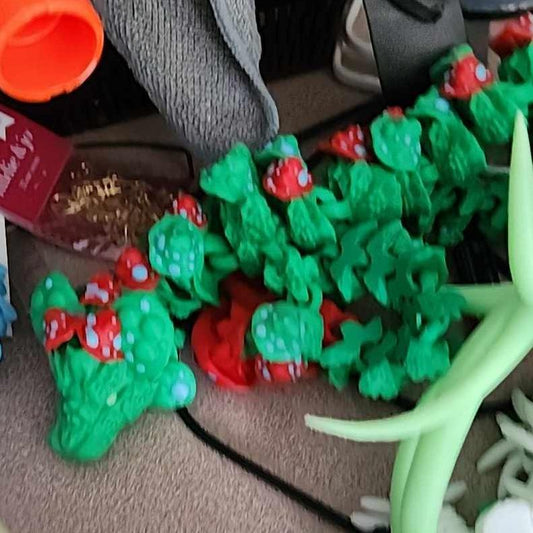 3D printed Mushroom Dragon articulated fidget toy with glow-in-the-dark blue eyes and feet
