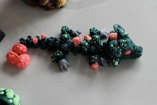 3D printed Mushroom Dragon articulated fidget toy with glow-in-the-dark blue eyes and feet
